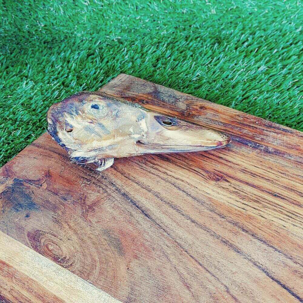 Duck Head Dog Treat on wooden board
