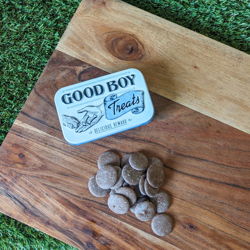 Retro good boy dog treats tin and carob drops displayed on wooden board Bonza Dog Treats