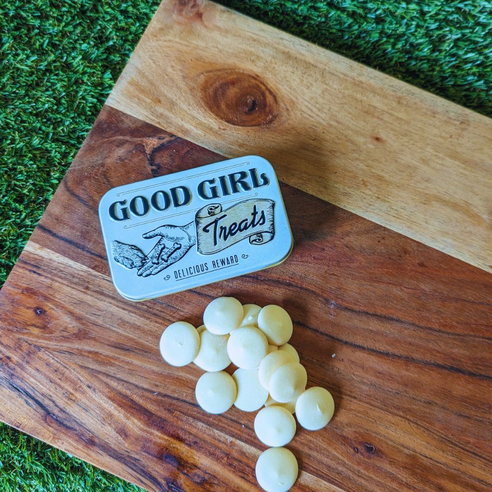 Retro good girl dog treats tin and yogurt drops displayed on wooden board Bonza Dog Treats