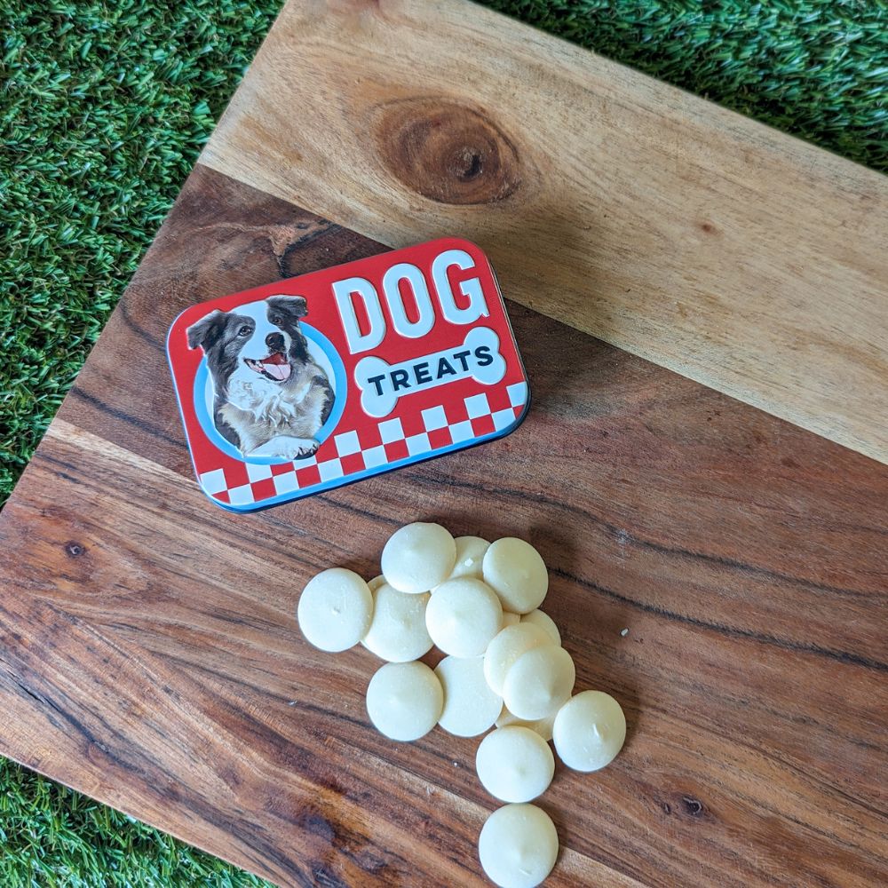 Retro dog treats tin and yogurt drops displayed on wooden board Bonza Dog Treats