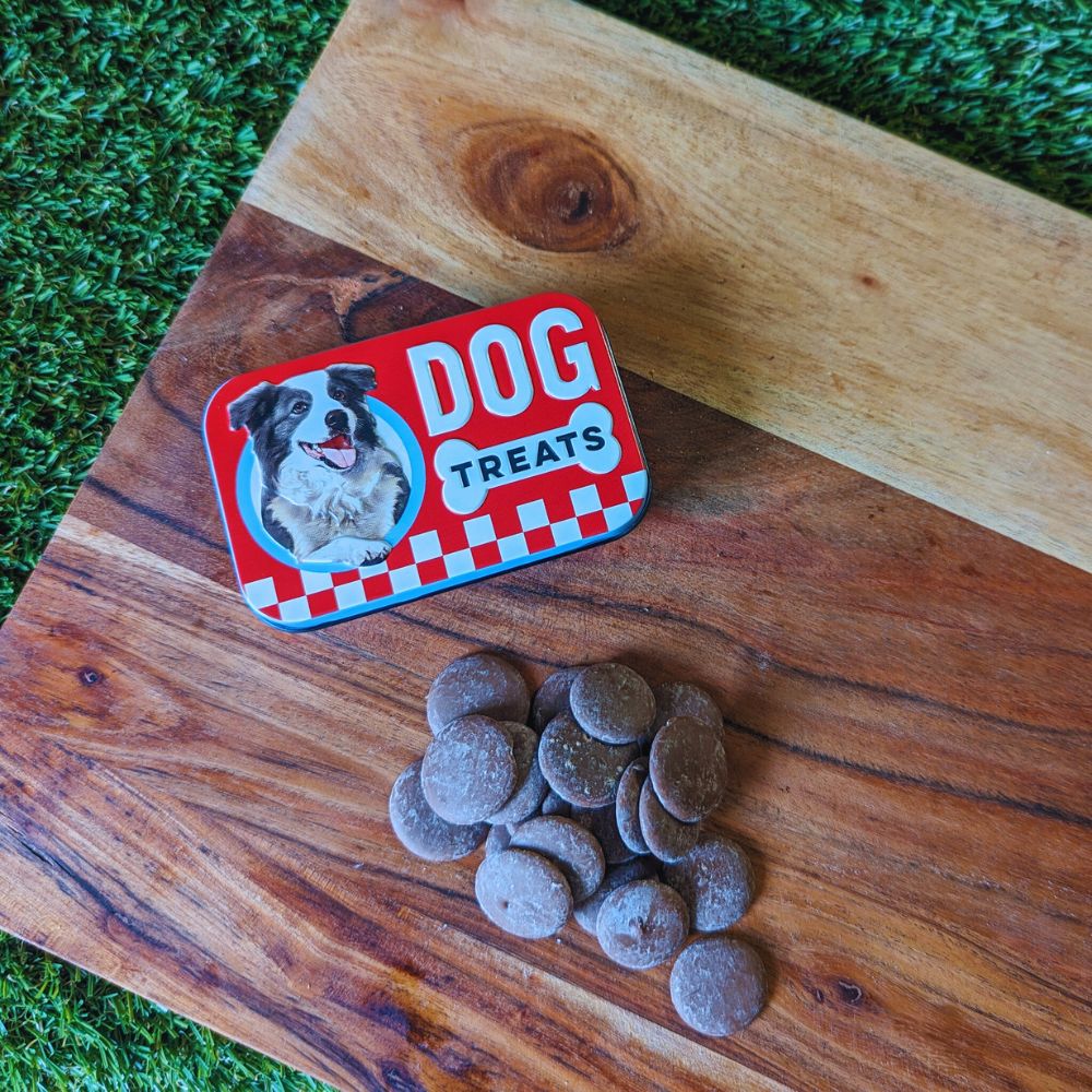 Retro dog treats tin and carob drops displayed on wooden board Bonza Dog Treats