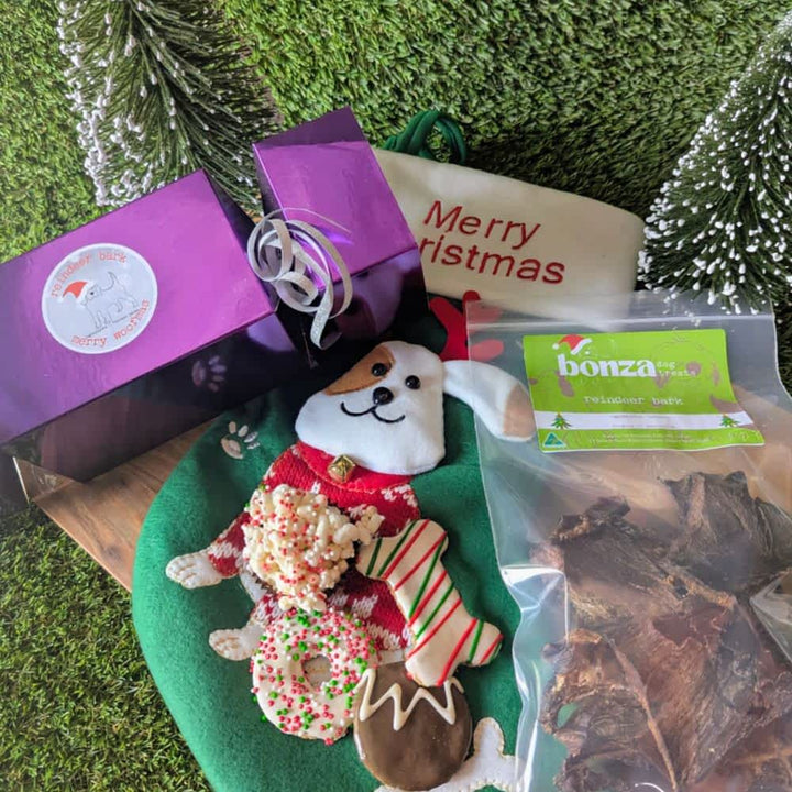 Reusable Santa Stocking stuffed with 6 exclusive festive dog treats, including cookies, bonbons, and venison jerky, the perfect Christmas gift for dogs | Bonza Dog Treats